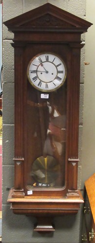 Lot 142 - An oak twin-weight Vienna wall clock, 128cm high
