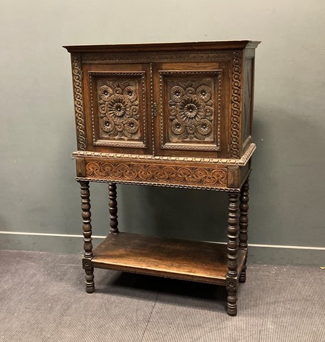 Lot 433 - A late Victorian carved oak cabinet on stand,...