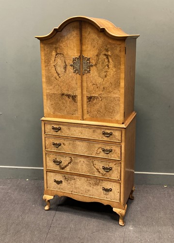 Lot 376 - A 1930's walnut linen press on short cabriole...