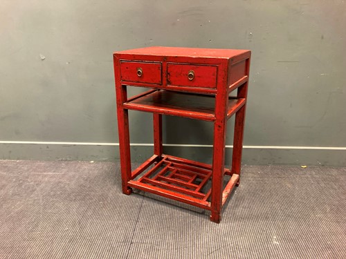 Lot 531 - A red lacquered side table with two drawers...