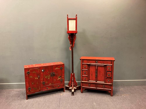 Lot 509 - A red lacquered cabinet with three doors and...