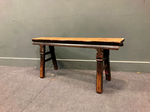 Lot 520 - A Chinese provincial elm topped bench with...