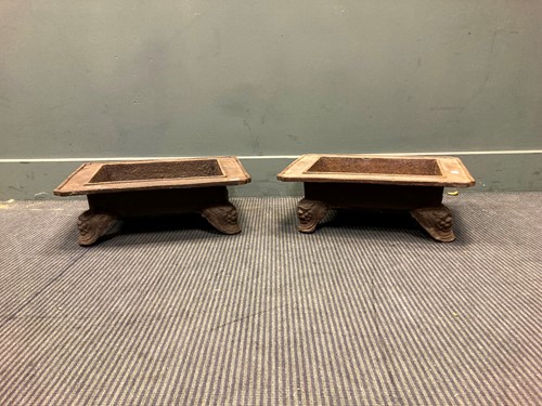Lot 530 - A pair of cast metal stands with Fo dog feet,...