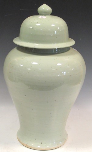 Lot 35 - A Chinese light green glazed ceramic lidded...