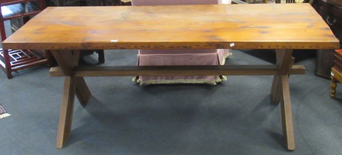Lot 437 - A pine trestle table with X shape ends, 75 x...