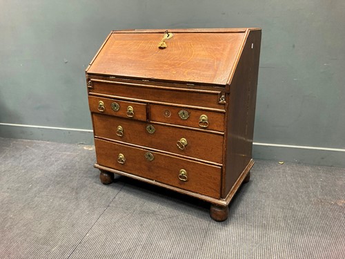 Lot 350 - An early 18th century oak bureau with two...