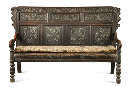 Lot 338 - A carved oak panel back settle, 17th century and later