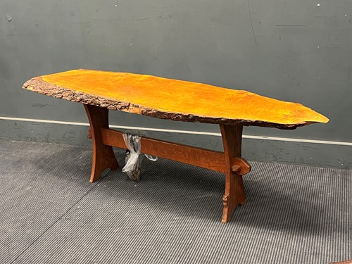 Lot 457 - An Owlman coffee table, the sliced top with...