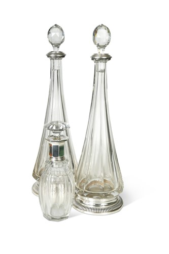 Lot 328A - A pair of French metalwares silver mounted cut glass decanters together with another example