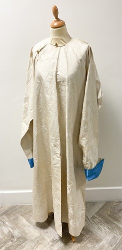 Lot 76 - A Chinese ivory silk brocade long jacket, early 20th century