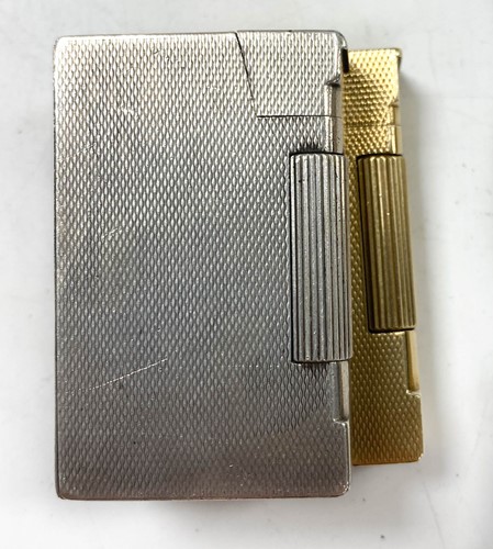Lot 108 - A 9ct gold pocket lighter by A D Bach and another silver example
