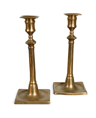 Lot 340 - A pair of brass candlesticks, 18th century