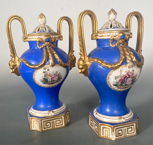 Lot 5 - A pair of Dresden two-handeld vases and covers,...