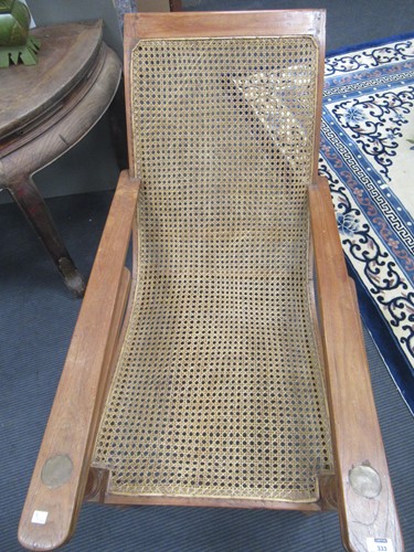 Lot 333 - A teak plantation chair, early 20th century,...