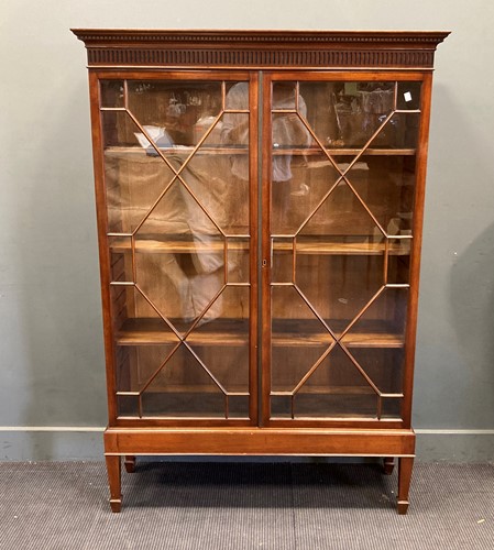 Lot 757 - A Georgian style mahogany glazed two door...
