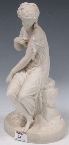 Lot 94 - A Copeland bisque female statuette with a bird...