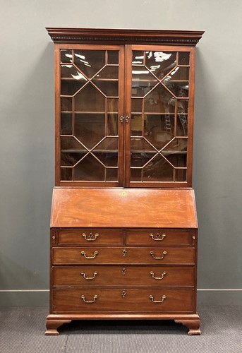Lot 463 - A George III mahogany bureau bookcase on ogee...