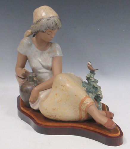 Lot 5 - A Lladro model of a young girl with a water...