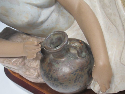 Lot 5 - A Lladro model of a young girl with a water...