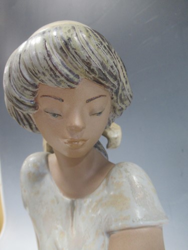 Lot 5 - A Lladro model of a young girl with a water...