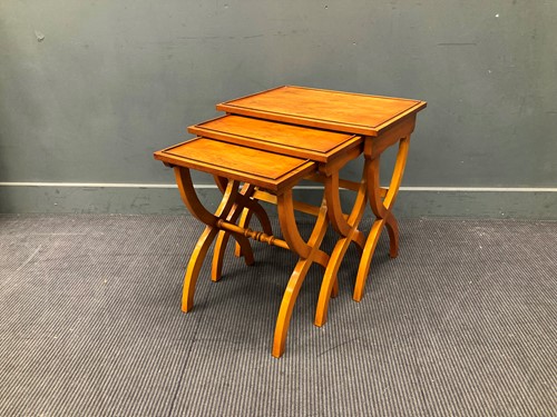 Lot 516 - A nest of three Yew wood occasional tables,...