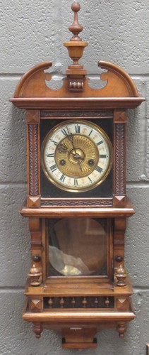 Lot 112 - An Austrian walnut clock with two-piece dial...
