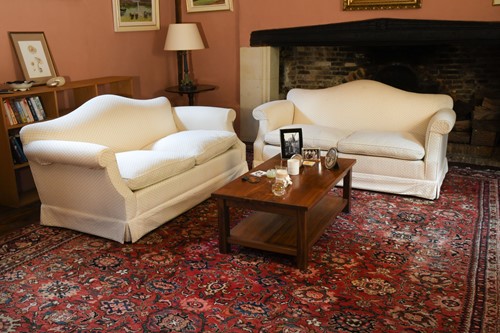 Lot 428 - A pair of modern camel back two seat sofas