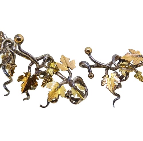 Lot 10 - Brett Payne - An 18ct gold and silver grape vine and corkscrew necklace