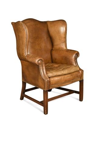Lot 528 - A George III style green leather wingback armchair, 20th century