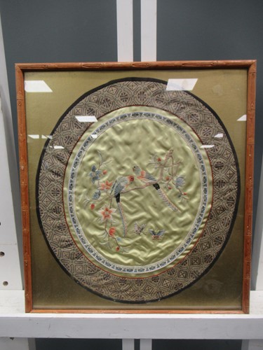 Lot 698 - An oval Chinese textile love birds, 39 x 34cm
