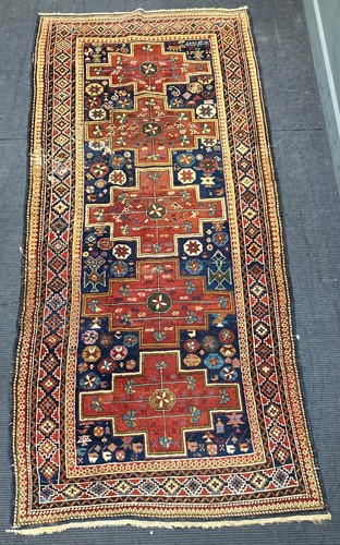 Lot 551 - A red and blue Karabagh with five lozenges to...