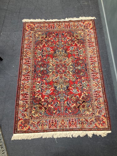 Lot 550 - A red ground Persian rug, late 20th century,...