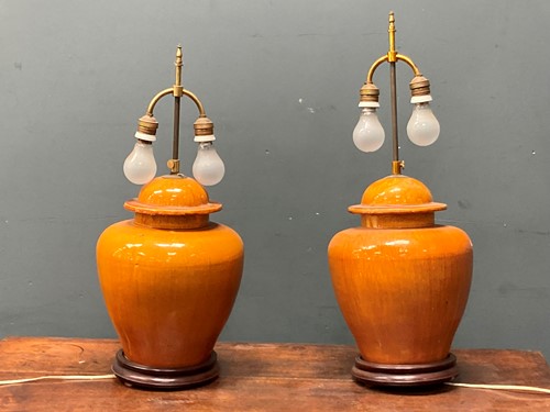 Lot 526 - A pair of orange glazed ceramic baluster vase...