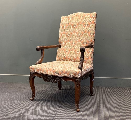 Lot 421 - A French Regence style walnut open armchair...