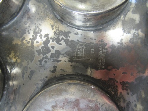 Lot 11 - A pewter shot holder tray with twelve red glasses