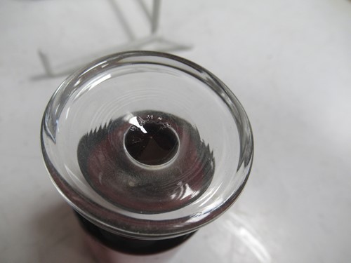 Lot 11 - A pewter shot holder tray with twelve red glasses