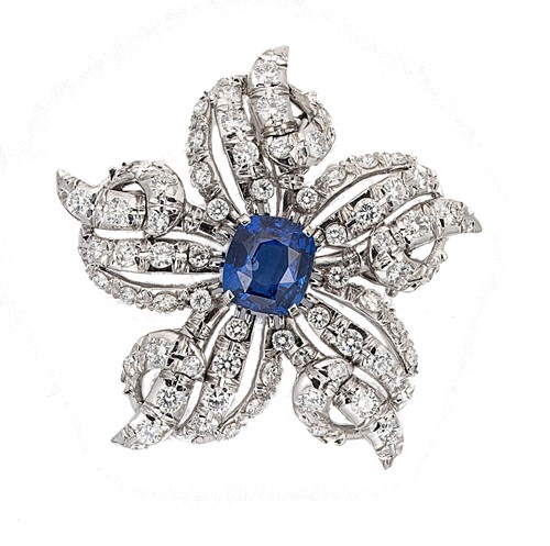 Lot 283 - A sapphire and diamond floral pendant/brooch