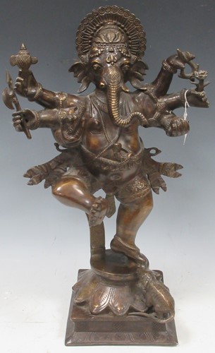 Lot 118 - A bronze multi-armed Ganesh holding weapons,...