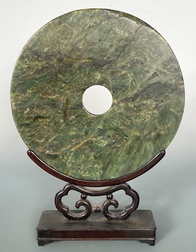 Lot 43 - A Chinese dark green jade bi-disc