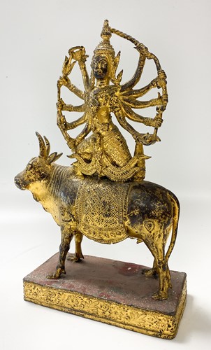 Lot 110 - A Thai (Rattanakosin) gilded and red-painted bronze of Shiva upon the Nandi Bull, 19th/20th century