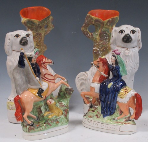 Lot 70 - A pair of Staffordshire vases modelled with...