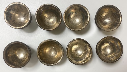 Lot 53 - A set of eight Chinese export carved and silver mounted coconut wood wine cups, Qing Dynasty, early 19th century