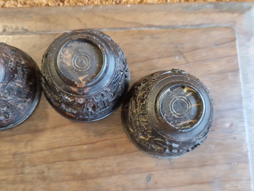 Lot 53 - A set of eight Chinese export carved and silver mounted coconut wood wine cups, Qing Dynasty, early 19th century