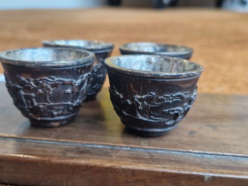 Lot 53 - A set of eight Chinese export carved and silver mounted coconut wood wine cups, Qing Dynasty, early 19th century