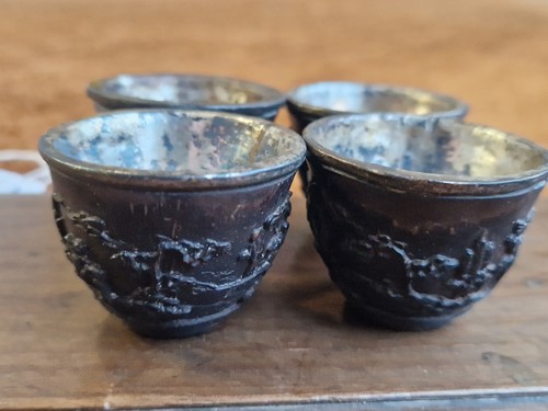 Lot 53 - A set of eight Chinese export carved and silver mounted coconut wood wine cups, Qing Dynasty, early 19th century