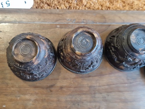 Lot 53 - A set of eight Chinese export carved and silver mounted coconut wood wine cups, Qing Dynasty, early 19th century