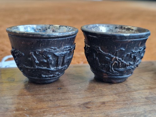 Lot 53 - A set of eight Chinese export carved and silver mounted coconut wood wine cups, Qing Dynasty, early 19th century