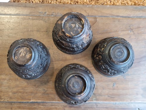 Lot 53 - A set of eight Chinese export carved and silver mounted coconut wood wine cups, Qing Dynasty, early 19th century