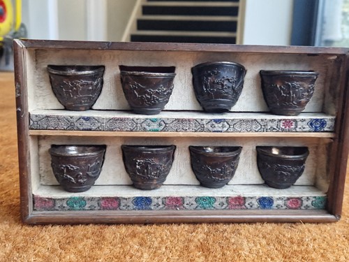 Lot 53 - A set of eight Chinese export carved and silver mounted coconut wood wine cups, Qing Dynasty, early 19th century