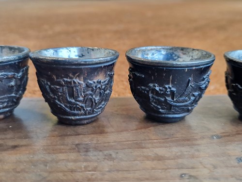 Lot 53 - A set of eight Chinese export carved and silver mounted coconut wood wine cups, Qing Dynasty, early 19th century